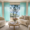 Light blue custom sheer curtains create an elegant, airy living space.