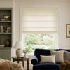 Natural linen Roman shade filtering light over a window in a modern living room