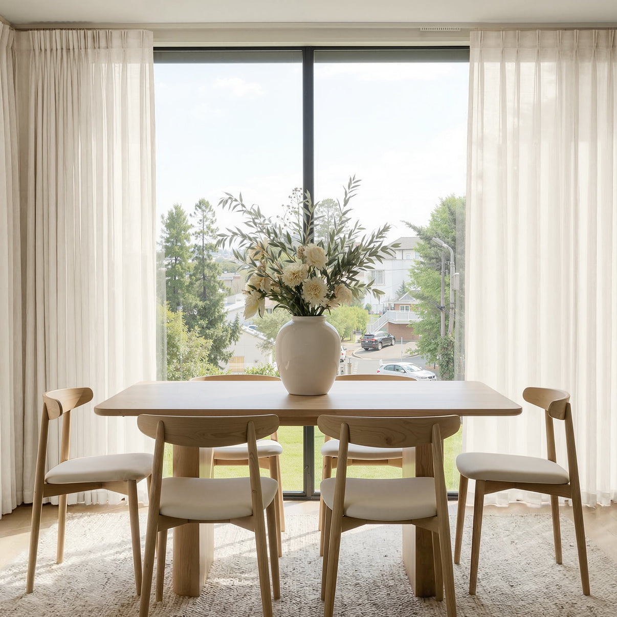 Sheer Willow linen light filtering curtains creating a bright, airy dining room.