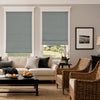 Textured blue-gray blackout Roman shades on two living room windows