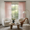 Soft pink geometric sheer curtains with pom-pom trim, custom window treatment.