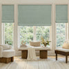Custom sage green faux linen blackout Roman shades.