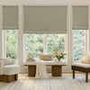 Custom taupe textured faux linen Alder Roman shade with blackout lining for light control.