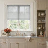 Joydeco Cove light filtering solar shade on a kitchen window, softening sunlight.